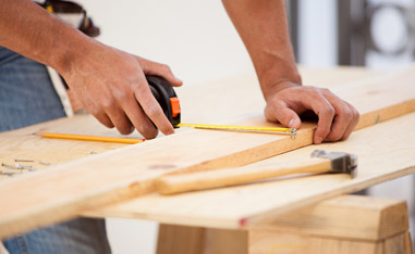 Man Measuring Lumber to be used for framing in Chicago Area Home Kitchen Remodeling Project